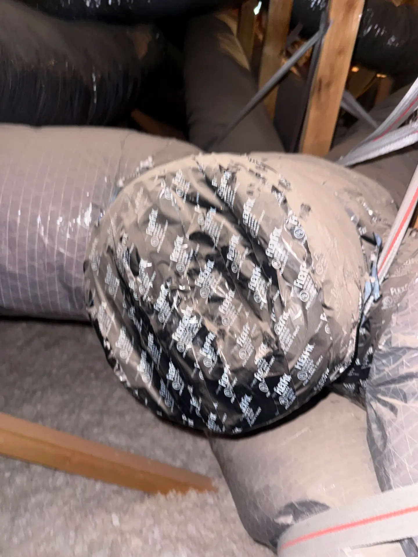 Air duct joint held together with tape before professional duct sealing